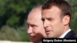 Russian President Vladimir Putin (left) and French President Emmanuel Macron speak during a meeting in St. Petersburg on May 24.