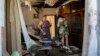 Local residents in Donetsk return to homes damaged by shelling in August.