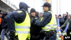 Police push back activists during a protest in Copenhagen 