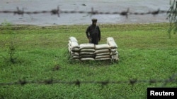 An Indian Army soldier stands guard close to the Line of Control, a cease-fire line dividing Kashmir between India and Pakistan. 