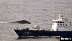 The sinking of the South Korean naval ship (top) in March killed 46.