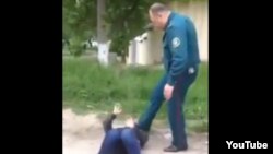 Uzbekistan - Police member beat a woman threatening her