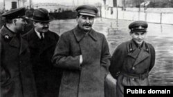 Soviet dictator Josef Stalin (center) and Soviet secret police head Nikolai Yezhov (right) walk near Moscow in 1937, the same year Yezhov signed Order No. 00447, which began the Great Terror.