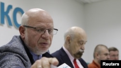 Members of the Russian Presidential Human Rights Council, Mikhail Fedotov (left), Valery Borshchyov (second left) Kirill Kabanov (third left), at a news conference concerning the investigation into Sergei Magnitsky's death.