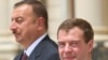 Azerbaijani President Ilham Aliyev (left) with his Russian counterpart, Dmitry Medvedev, in July. It is easy to see how Aliyev is calculating.