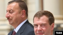Azerbaijani President Ilham Aliyev (left) with his Russian counterpart, Dmitry Medvedev, in July. It is easy to see how Aliyev is calculating.