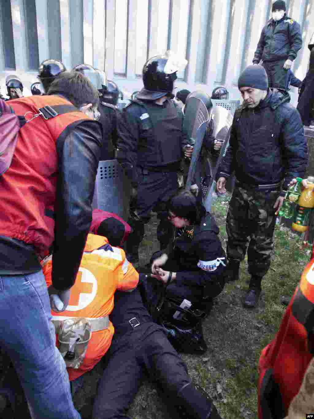 A wounded policeman receives medical assistance following clashes with pro-Russian activists who stormed the SBU building in Lugansk.&nbsp;