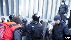 A wounded policeman receives medical assistance following clashes with pro-Russian activists in Luhansk.