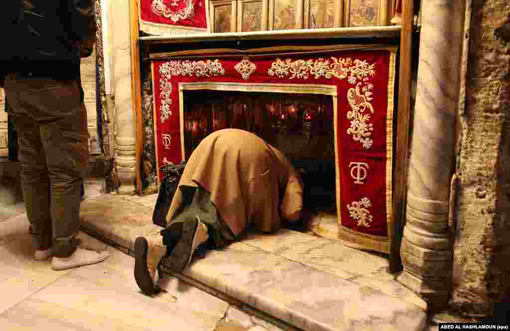 A woman prays in the Church of the Nativity in the West Bank city of Bethlehem. The grotto in the church is considered by Christians to be the birthplace of Jesus Christ. 