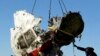 Local workers transport a piece of wreckage from Malaysia Airlines flight MH17 in the Donetsk region, where the plane was shot down in 2014, killing all 298 people on board.