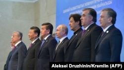 Leaders of the SCO countries pose for on June 14.