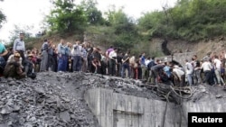 People gather at the site of an explosion in a coal mine in Golestan Province, in northern Iran on May 3. 