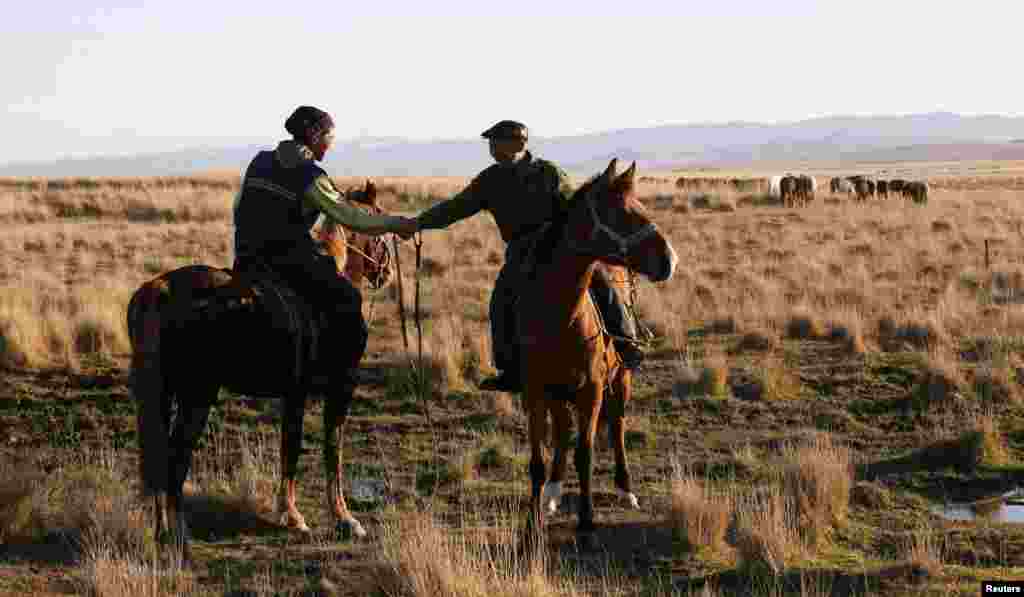 Herders greet on the plains of Russia's Tuva Republic, where shamanism is practiced alongside Buddhism. Shamans claim that today around a quarter of all Siberians practice shamanism to some extent, though researchers say that number is inflated. 