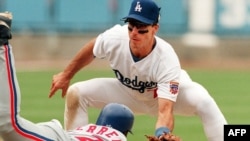 The Dodgers' Greg Gagne tags out a Montreal Expos baserunner during a 1997 Major League Baseball game.