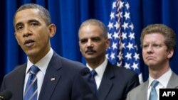 U.S. President Barack Obama speaks alongside Attorney General Eric Holder and Shaun Donovan (left to right), secretary of housing and urban development, in Washington in February.