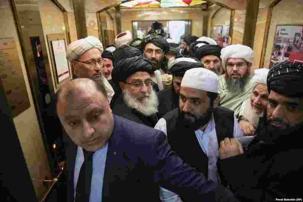 Taliban officials get into an elevator as they attend &quot;intra-Afghan&quot; peace talks in Moscow on February 6. (AP/Pavel Golovkin)