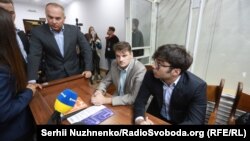 Ukrainian deputy Nestor Shufrych (left) and his son, also called Nestor (right), at a court hearing in Kyiv on August 30. 