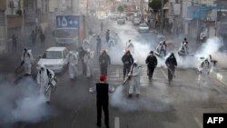 Iranian firefighters disinfect streets in a bid to halt the spread of coronavirus in Tehran on March 13.