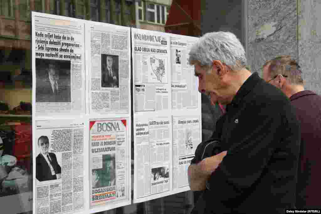 Sarajevans stop to look at pages from war-era newspapers posted in shop fronts along the city&rsquo;s main Titova Street as part of the commemorations.
