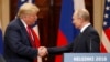 U.S. President Donald Trump (left) and Russian President Vladimir Putin shake hands at a summit in Helsinki last year. 