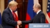 U.S. President Donald Trump (left) and Russian President Vladimir Putin shake hands during a joint press conference following their summit talks in Helsinki in July 2018.
