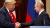 U.S. President Donald Trump (left) and Russian President Vladimir Putin shake hands during a joint press conference following their summit talks at the Presidential Palace in Helsinki on July 16.