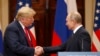 U.S. President Donald Trump (left) and Russian President Vladimir Putin shake hands at their summit in Helsinki in July. 