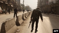A rebel fighter walks on the streets of the northern Syrian city of Aleppo on January 10.