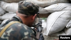 A pro-Russian fighter mans a checkpoint in the eastern Ukrainian city of Donetsk on July 7. 