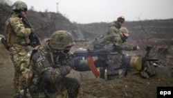 Servicemen of the Ukrainian volunteer battalion 'Azov' practice firing during military training near Mariupol on January 27. 