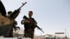 Afghan National Army (ANA) soldiers keep watch at a checkpoint on the Ghazni - Kabul highway on August 14.