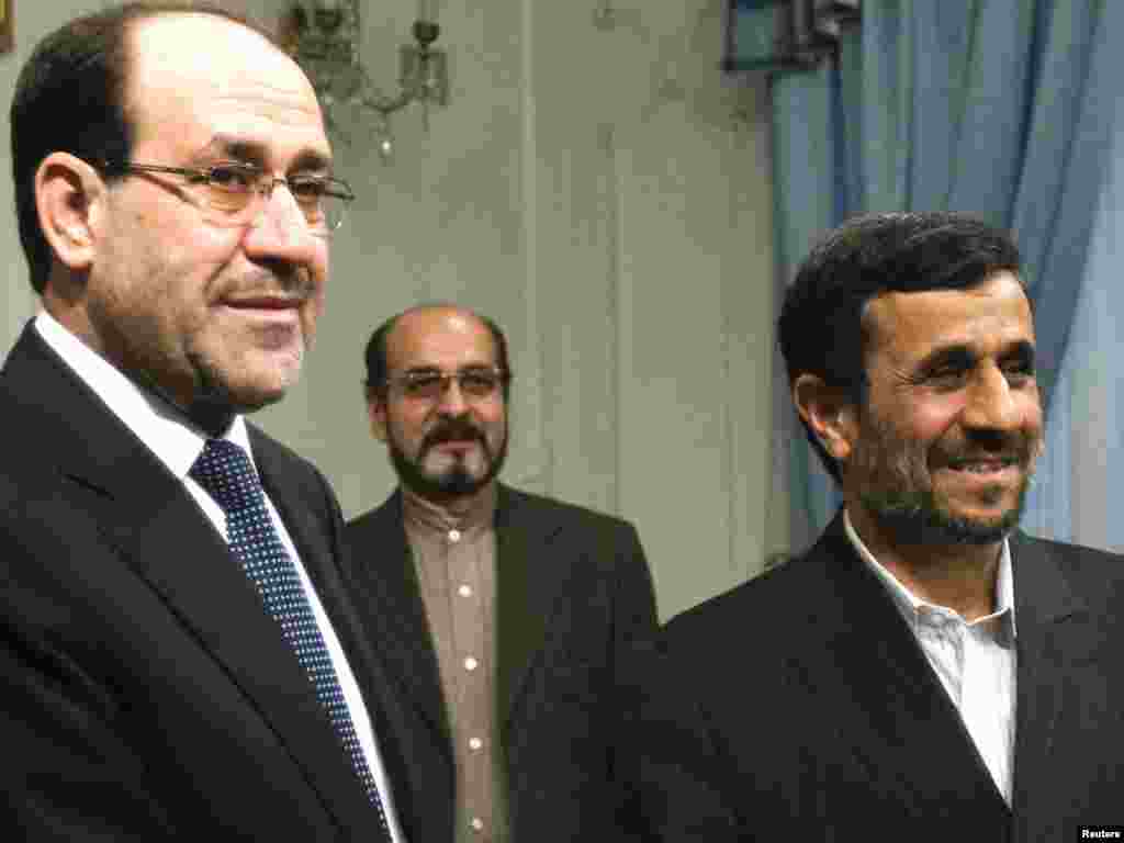 Iran -- President Mahmud Ahmadinejad (R) meest with Iraqi Prime Minister Nuri al-Maliki in Tehran, 18Oct2010 - Iran's President Mahmoud Ahmadinejad (R) shakes hands with Iraq's Prime Minister Nuri al-Maliki during an official meeting in Tehran October 18, 2010. REUTERS/Raheb Homavandi (IRAN - Tags: POLITICS)