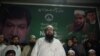 FILE: The head of Pakistani militant organziation Jamaat-ud-Dawa (JuD) Hafiz Saaed (C) along with his newly formed political party Allah-o-Akbar Tehreek nominated candidate Chaudhry Saeed Ahmed (L), speaks to supporters in June.