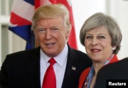 U.S. President Donald Trump greets British Prime Minister Theresa May as she arrives at the White House in Washington on January 27.