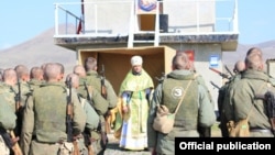 Armenia - A Russian Orthodox Church priest blesses Russian soldiers holding exercises at the Kamkhud shooting range, 14Oct2014. 
