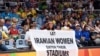 A woman holds a banner reading "Let Iranian women enter their stadiums" during a volleyball match between Russia and Iran in Rio de Janeiro on August 2016 during the Rio 2016 Olympic Games.