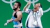 Nijat Rahimov, left, of Kazakhstan is celebrated by a member of the coaching staff after a world record attempt in Clean & Jerk in the men's 77kg category final of the Rio 2016 Olympic Games Weightlifting events on August 10.