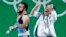 Nijat Rahimov, left, of Kazakhstan is celebrated by a member of the coaching staff after a world record attempt in Clean & Jerk in the men's 77kg category final of the Rio 2016 Olympic Games Weightlifting events on August 10.