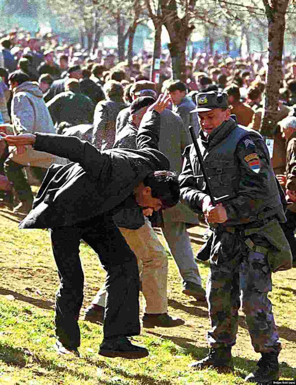 A Serbian policeman clashes with an ethnic Albanian demonstrator in Pristina, Kosovo, in 1998. The protests erupted after a weekend of violence that saw 20 people killed in clashes between Serb police and members of Kosovo&#39;s ethnic Albanian majority.