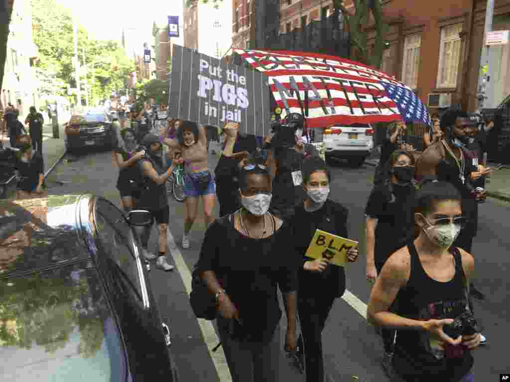 U.S. -- New Yorkers assemble in Washington Square Park and march along 6th Avenue to protest police brutality during the Coronavirus Pandemic in New York City.