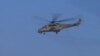 A helicopter flies over Anbar Province during Iraqi military air strikes.