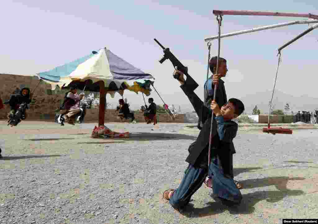 Afghan children ride a swing during the first day of the Muslim holiday of Eid al-Fitr, which marks the end of the holy month of Ramadan, in Kabul on June 15. (Reuters/Omar Sobhani)