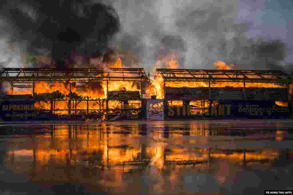 Burmese law enforcement authorities burn impounded illegal drugs on the International Day against Drug Abuse and Illicit Trafficking during a ceremony in Yangon on June 26. (AFP/Ye Aung Thu)