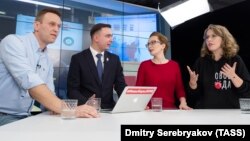 Navalny LIVE hosts Yelena Malakhovskaya (second from right) and Ivan Zhdanov in the studio along with opposition leader Aleksei Navalny (left) and presidential candidate Ksenia Sobchak (right)