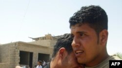 Weeping family members of an off-duty policeman and his brother who were shot dead in Kirkuk on May 21.