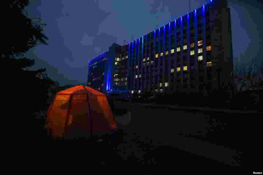 A woman is silhouetted in a first-aid tent outside the regional government building in Donetsk, Ukraine, occupied by pro-Russian forces. (Reuters/Baz Ratner)