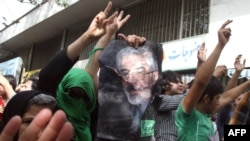 Opposition supporters chant slogans in support of Mir Hossein Musavi (in portrait), as they protest during a rally marking Quds (Jerusalem) Day in Tehran.