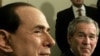 United Stated-- Washington : US President George W. Bush and Italian Prime Minister Silvio Berlusconi (L) listen to reporter's questions as they meet privately in the Oval Office of the White House 28 February 2006 in Washinton, DC