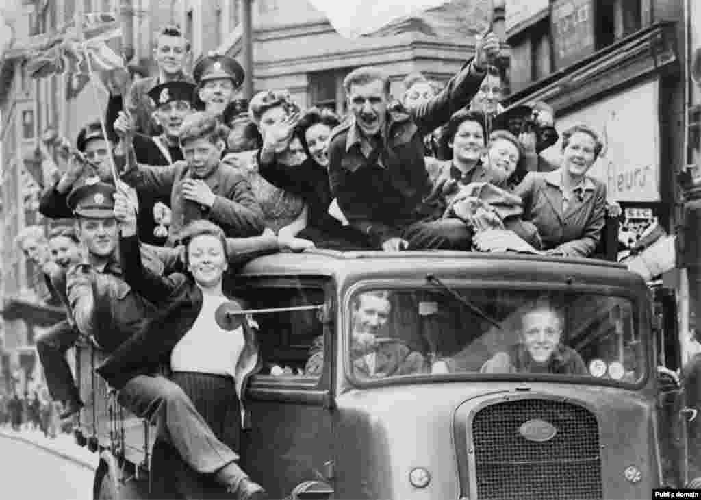 A packed pickup rolls through London. A witness to London&rsquo;s giant party described an infectious atmosphere that &ldquo;combusted spontaneously in the bosom of every member of every family, from the smallest babies, with their hair done up in&hellip;ribbons to beaming elderly couples who, utterly without self-consciousness, strolled up and down the streets arm in arm in red, white, and blue paper hats.&rdquo;