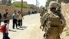 U.S. Marines are pictured here with Iraqi schoolchildren in Haditha. 